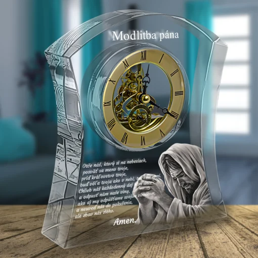 Transparent curved glass sculpture enclosing a gold clock face with Roman numerals, overlaid with white Slovak text; a kneeling figure is visible nearby on a wooden floor.