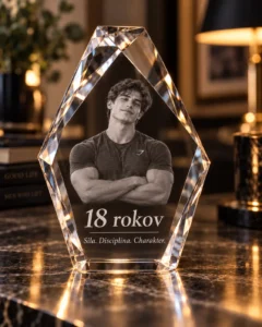 Crystal trophy with a photo of a muscular man in a grey T-shirt, arms crossed, inscribed '18 rokov' and 'Sila. Disciplina. Charakter.'
