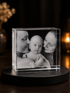 Crystal cube keepsake showing a black-and-white family photo: baby with two adults on either side.