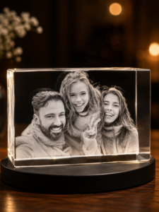 Black-and-white photo of a smiling man with two girls inside a glass display block on a wooden table.