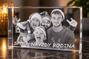 Black-and-white photo of five people and a dog wearing Santa hats, framed in a clear glass block; text reads 'SPOLU NAVZDY RODINA'.
