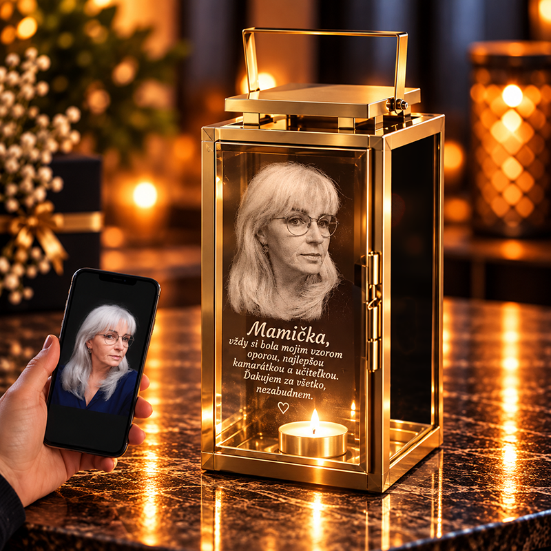 Gold lantern memorial holding a portrait of a woman, a lit candle, and Slovak dedication to 'Mamička' (mom).